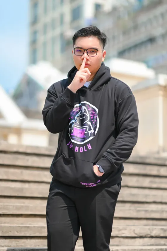 Portrait of Jok Holk wearing a black hoodie with the Jok Holk logo